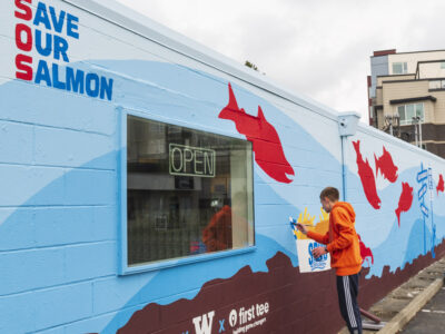 Austin Picinich standing in front of Save Our Salmon mural.