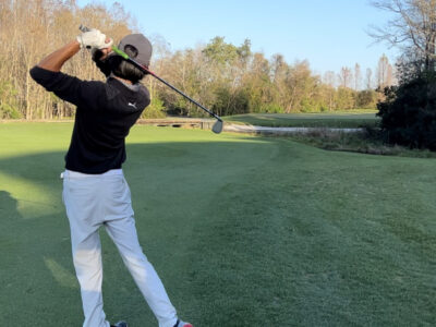 Boy playing golf.