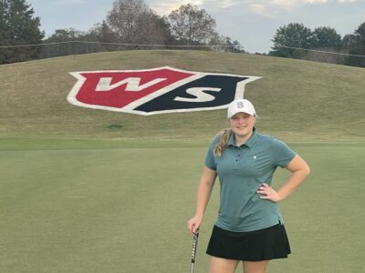 Girl posing on golf course.